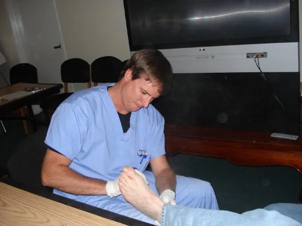 Profesional de la podología atendiendo el pie de un paciente